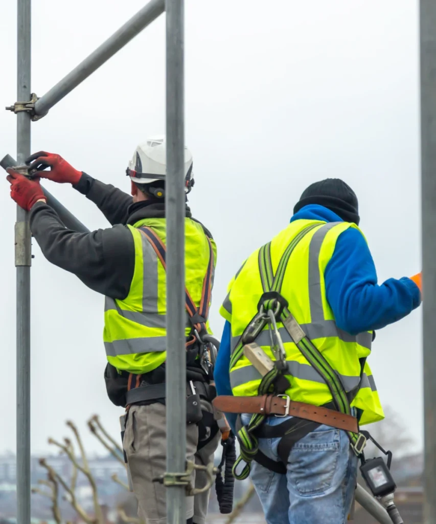 Professional scaffolders assembling a scaffolding structure